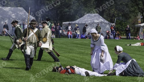 Preview: Wheaton, Illinois/Usa - September 12, 2015: Two Young Women Nurses Attend To A Fallen Soldier While