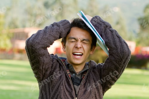 Preview: Frustrated Male Student Standing Outdoors With Notebooks