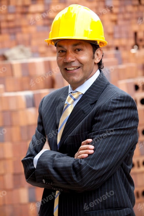 Preview: Elegant Engineer Smiling In A Construction With His Arms Crossed