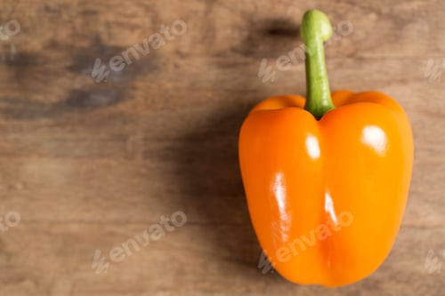 Preview: Fresh Raw Orange Pepper On Wooden Kitchen Work Surface