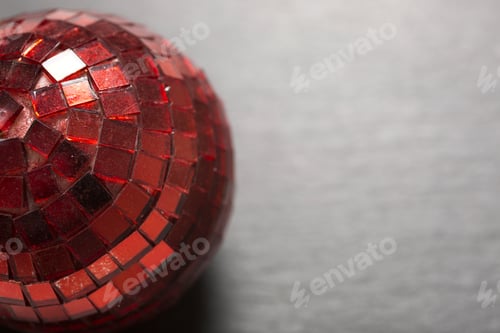 Preview: Delicate Red Mirror Christmas Bauble On A Dark Slate Surface