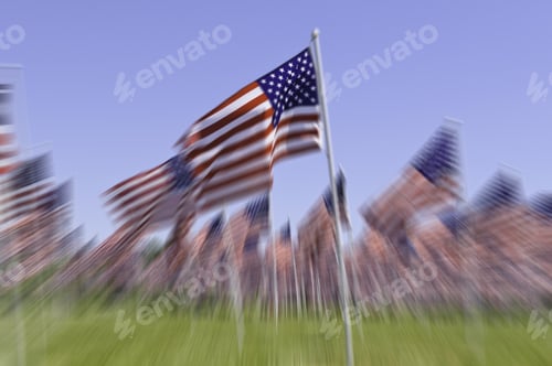 Preview: Radial Blur Of Many American Flags Standing Together, With Foreground Flag Prominent, On Green Lawn