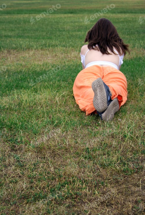 Preview: Beautiful Girl Lying Down On The Grass - Focus On Shoes