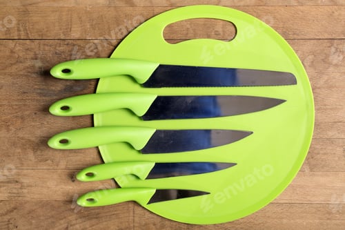 Preview: Stylish Collection Of Modern Kitchen Knives On A Green Chopping Board