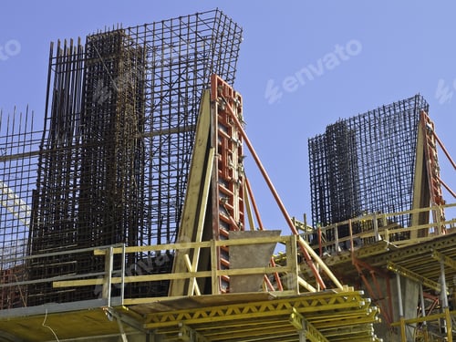 Preview: Two Tall Cages Of Reinforcement Steel To Strengthen Cast Concrete On Construction Site
