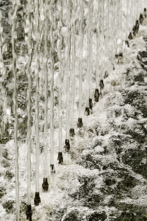 Preview: Upward Together In A Formal Garden: Row Of Spouts With Jets Of Water In Long Fountain For