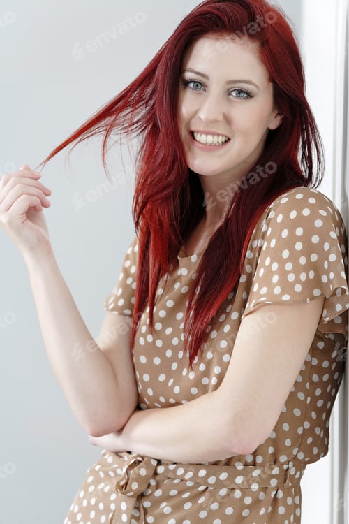 Preview: Beautiful Happy Young Woman In A Summer Dress Leaning Against A Wall.
