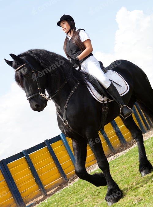 Preview: Female Jockey Horseback Riding A Black Horse