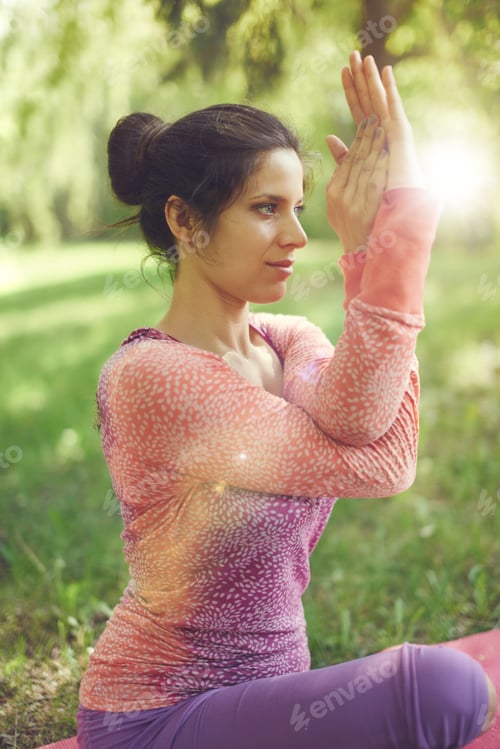 Preview: Serene And Peaceful Woman Practicing Mindful Awareness By Meditating In Nature With Sun Flare.
