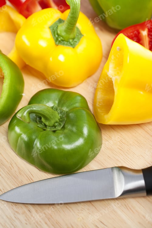 Preview: Selection Of Red Green And Yellow Peppers Sliced Up On A Chopping Board