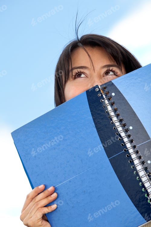 Preview: Portrait Of A Student With A Notebook Looking Up