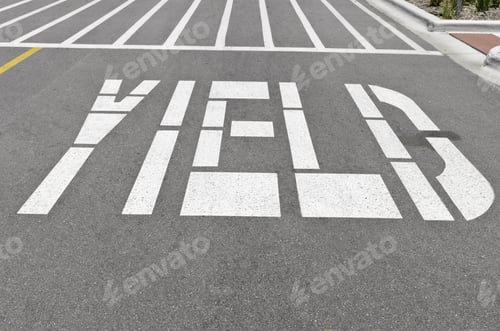 Preview: "Yield" Painted In White Capital Letters On Pavement