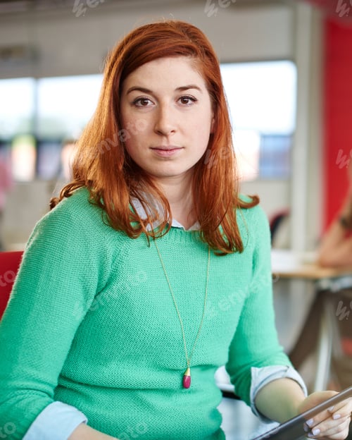 Preview: Confident Female Designer Working On A Digital Tablet In Red Creative Office Space
