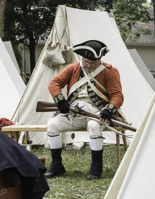 Preview: Wheaton, Illinois/Usa - September 13, 2014: An Actor In Uniform Checks His Musket Before He Takes