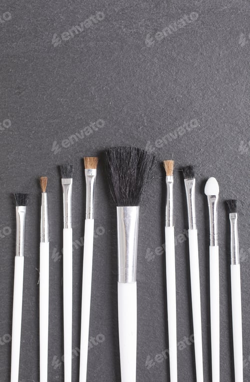 Preview: Stylish Make Up Brushes On A Black Slate Surface Of All Sizes