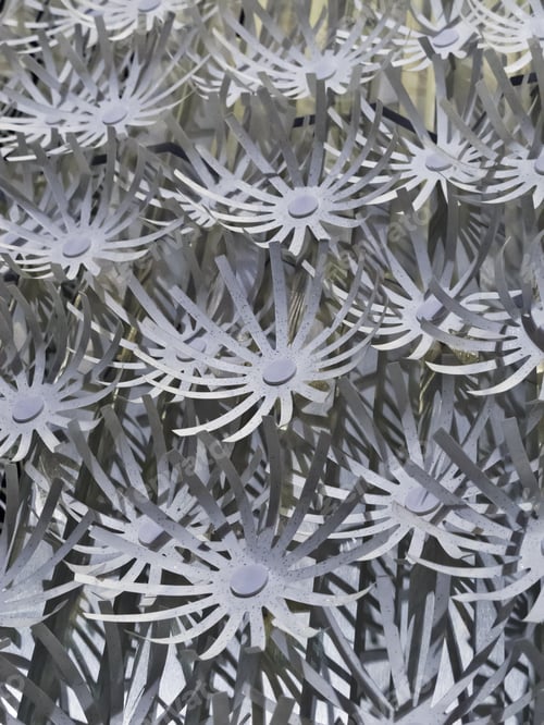 Preview: Faux Vertical Garden: Pattern Of Glittery, Curved, Flowerlike Cutouts Of Neutral Blue-Gray