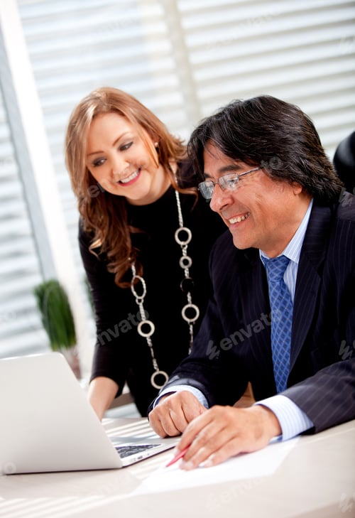 Preview: Business Couple Working At The Office And Smiling