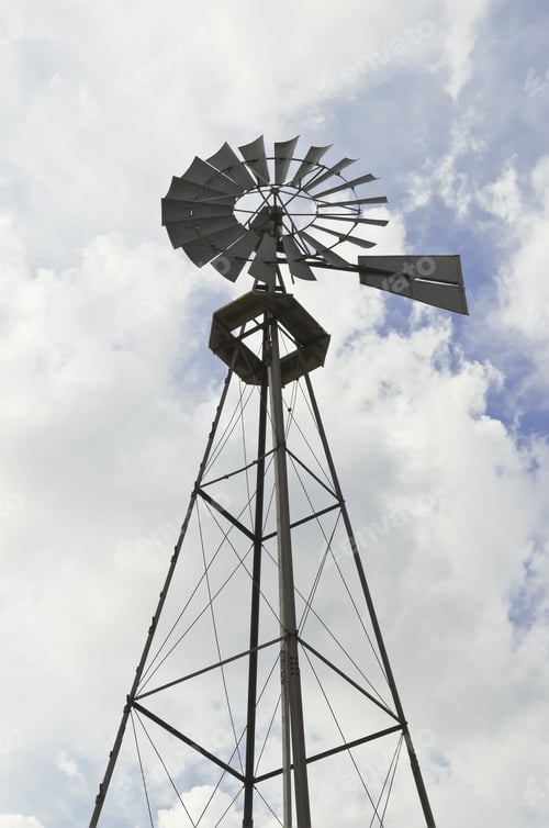 Preview: Top Of Weather Vane On Old Farm Stands Outlined Against Partly Cloudy Sky In Summer