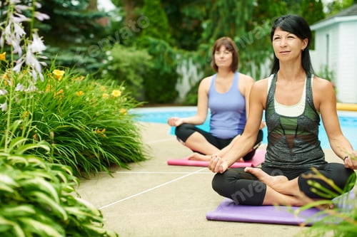 Preview: Two Mature Women Keeping Fit By Doing Yoga In The Summer