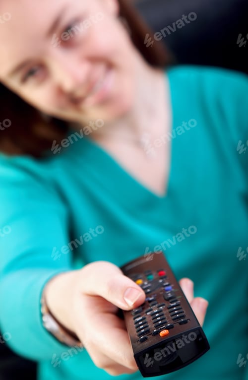 Preview: Beautiful Woman Holding A Television Remote Control