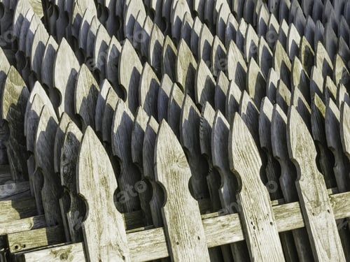 Preview: Pattern Of Weathered Wooden Fence Posts, Shaped Like Arrowheads, Near Sunset