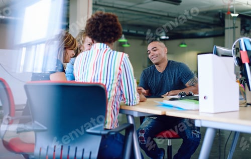 Preview: Unposed Group Of Creative Business People In An Open Concept Office Brainstorming Their Next