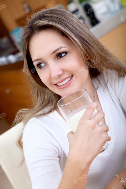 Preview: Woman Drinking A Glass Of Milk And Smiling