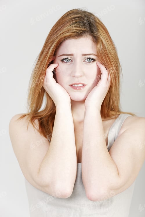 Preview: Young Woman Holding Her Head In Her Hands Expressing Concern