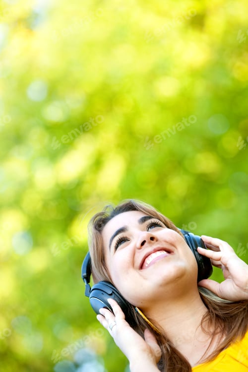 Preview: Portrait Of A Woman Outdoors Smiling With Headphones