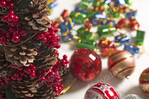 Preview: Selection Of Vibrant Christmas Decorations On A Light Wooden Surface