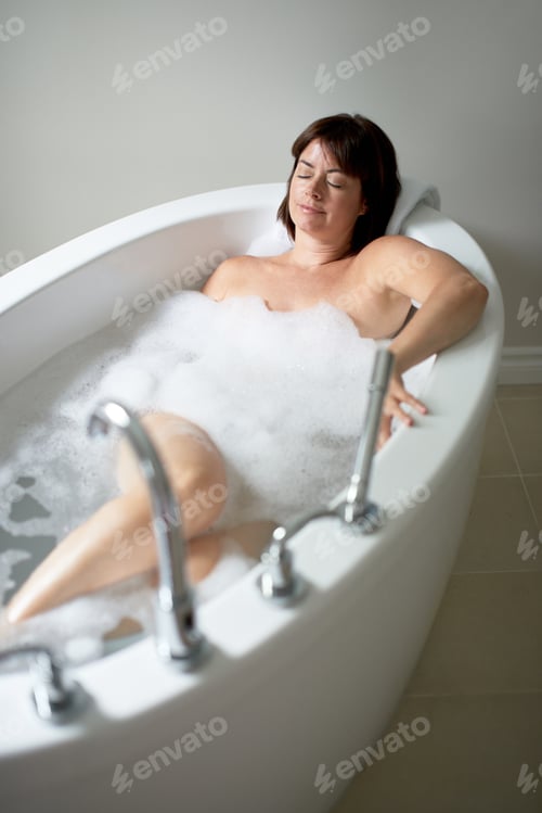 Preview: Serene Mature Woman With Her Eyes Closed In A Bathtub