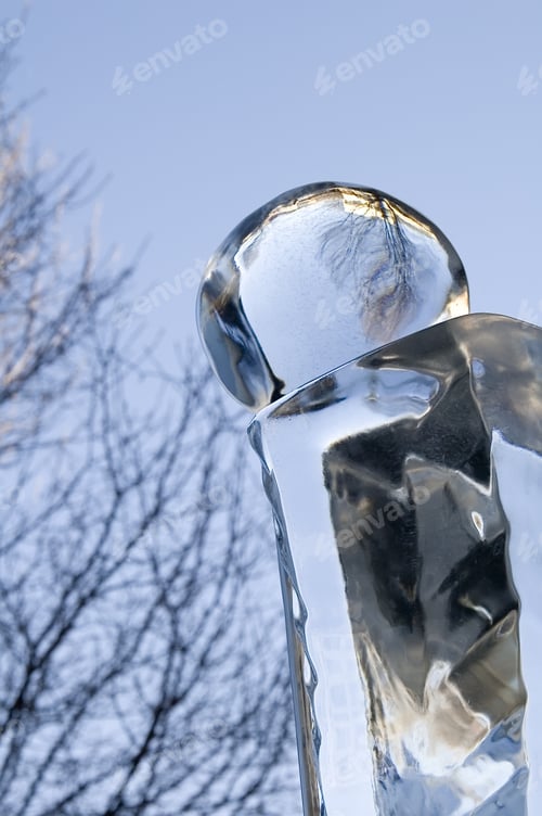 Preview: Reflective Ball Of Carved Ice, With Background Of Tree And Sky, In Winter