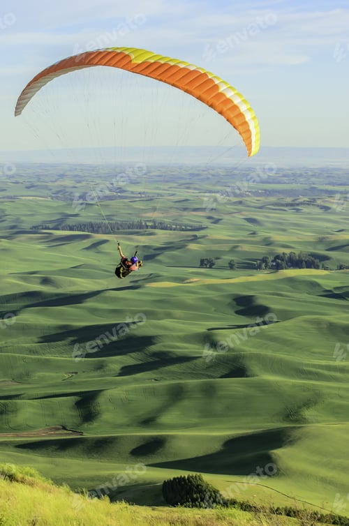 Preview: Adult Male Paraglider Banking Right Above Rolling Hills Of The Palouse In Western Washington, Usa