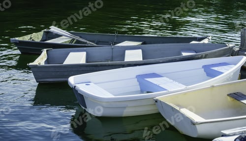 Preview: Four Rowboats, One With A Pair Of Oars, Tied Up To Dock In Maine