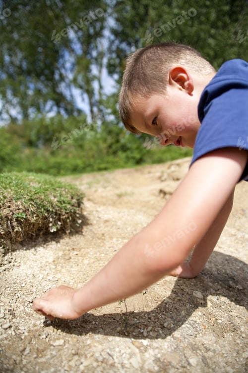 Preview: Young Boy Searching For Treasure In The Sand And Mud