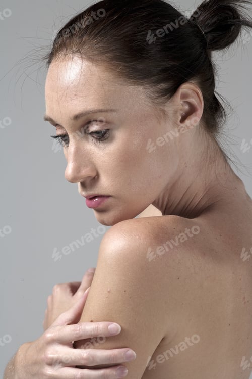 Preview: Woman Posing with Arms Crossed in Studio Setting