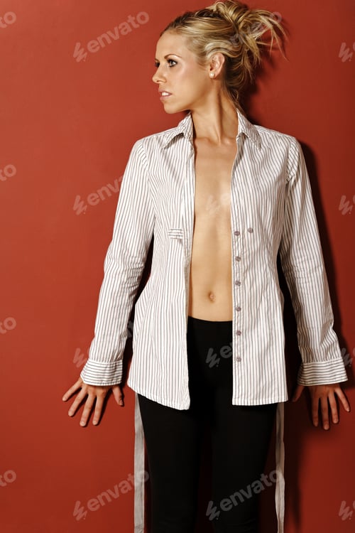 Preview: Young Woman Posing in Open Shirt Against Wall