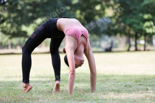 Preview: Asian Woman Doing Yoga With Stretching Body Outdoor In The Park. Woman Wearing Sportswear And
