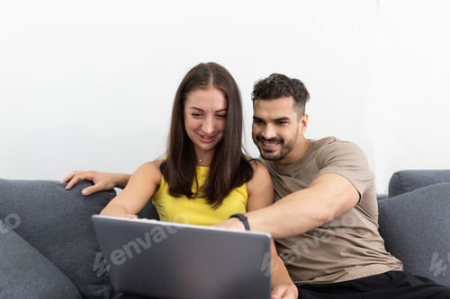 Preview: Smiling Couple Enjoying Laptop on the Sofa