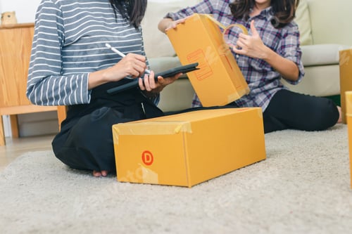 Preview: Beautiful Young Asian And Friend Happy Holding Tree From Boxes.Young Asian Women Working With Box