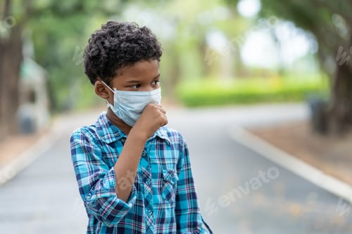 Preview: Spreading Of Disease Virus Concept. Boy Put On A Protective Medical Mask For Protect Coronavirus Or