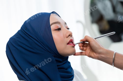 Preview: Makeup Artist Applying With Brush Eyes Shadow With Young Muslim Woman In Hijab Headscarf