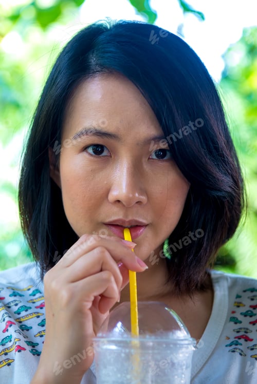Preview: Asian Women Is Drinking Icetea At The Cafe