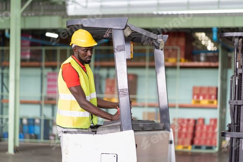 Preview: African American Male Warehouse Worker In Safety Vest And Helmet Driving And Operating On Forklift