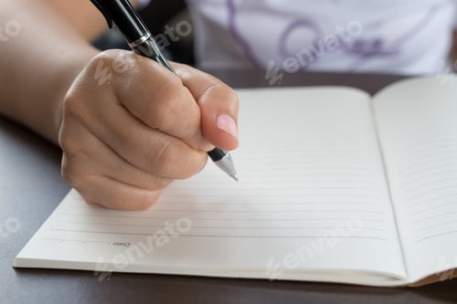 Preview: Closeup Of Woman'S Hand Writing On Paper Book