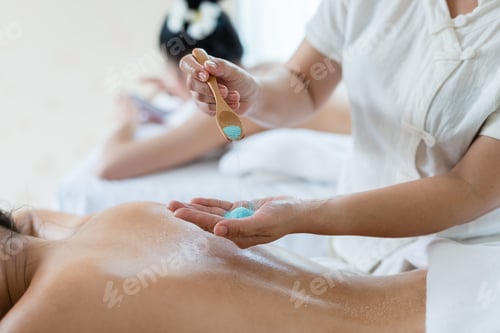 Preview: Hand Of Masseuse Sprinkle Salt Down At Back While Young Asian Woman Relaxing In The Spa Having Salt