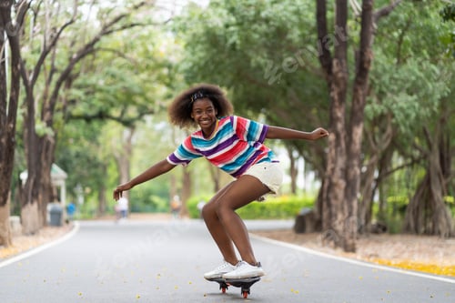 Preview: African American Young Girl Having Fun Riding Skateboard At Summer Outdoor. Teenager Girl