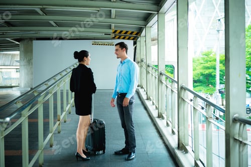 Preview: Young Business Leader Concept. Young Business Man And Woman Walking Down The Street In Urban City