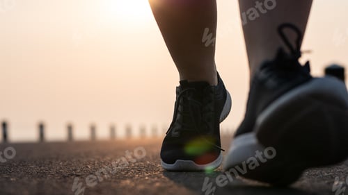 Preview: Close Up Bottom View Of Women Jogging In The Street In The Early Morning Sunlight. Concepts Of