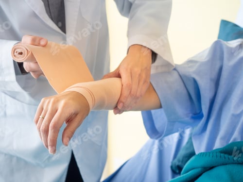 Preview: Close Up Doctor Wrab Bandage To Patient Arm